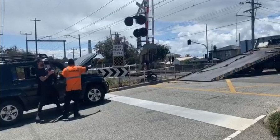 tow truck blocking train tracks